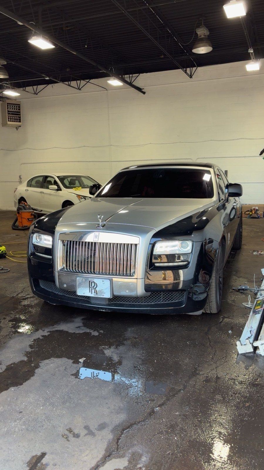Silver and black Rolls-Royce Ghost front-on in the Zoom Aesthetics shop